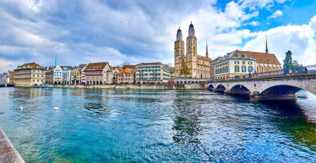 Panorama of the Limmat river with Munsterbrucke bridge and Grossmunster with houses on the river's bank, Zurich, Switzerland