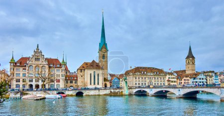 Panorama of the riverside housing of Limmat river with bell towers of Peterskirche and Fraumunster churches, Zurich, Switzerland