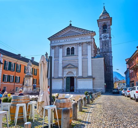 The facade of Sant'Antonio Church behind the outdoor dining on Piazza Sant'Antonio, Locarno, Switzerland