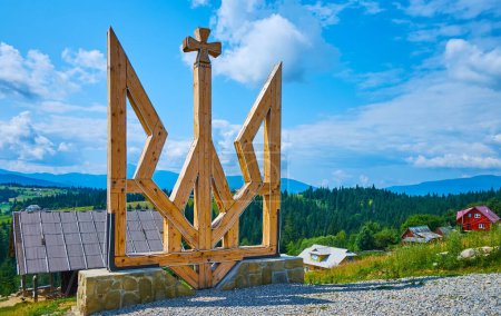 The big wooden Tryzub (Ukrainian Trident) against the green Carpathians, Mountain Valley Peppers, Ukraine