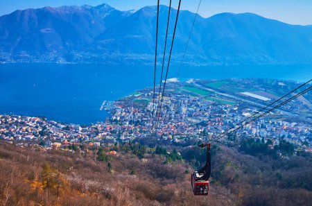 The car of Cardada Cimetta cableway over the forest on the mountain slope, Locarno, Ticino, Switzerland
