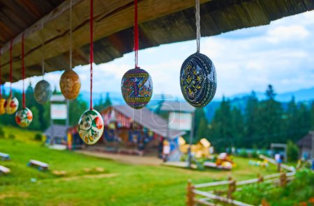 The hilly landscape of the handicraft village with wooden houses and the hanging Easter Eggs in the foreground, Mountain Valley Peppers, Ukraine