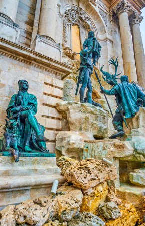 Matthias Fountain with bronze sculptural group of King Matthias, hunters, hounds, Helen the Fair, located on the side wall of Buda Castle, Budapest, Hungary