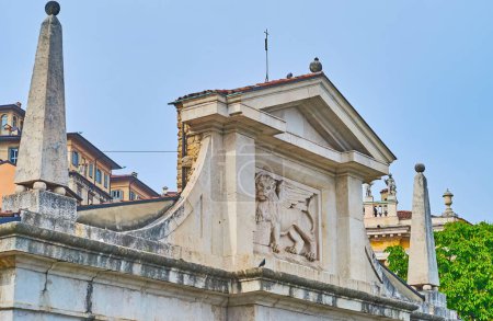 The pediment of the sculptured marble Porta San Giacomo gate, decorated with Winged Lion of St Mark, Bergamo, Italy