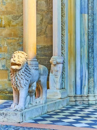 The sculptures of the ancient lion column base and female Telamon behind it, Porta dei Leoni Bianchi, Basilica, Santa Maria Maggiore, Bergamo, Italy