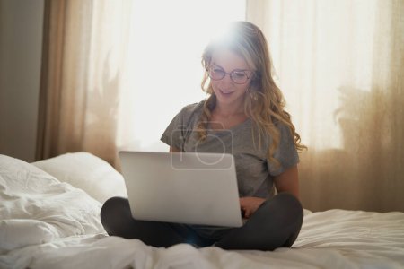 Photo for Caucasian woman using the laptop at home in morning - Royalty Free Image