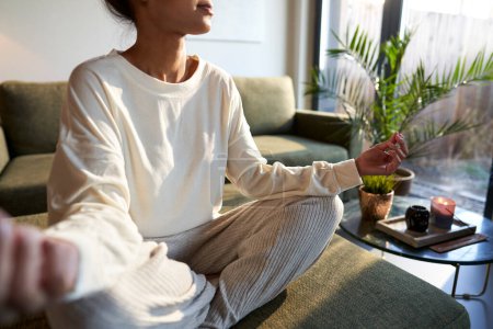 Photo for Part of mixed race woman meditating at home - Royalty Free Image