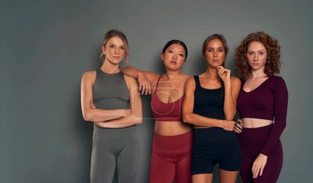 Téléchargez les photos : Four confident young women in sports clothes in studio shot - en image libre de droit