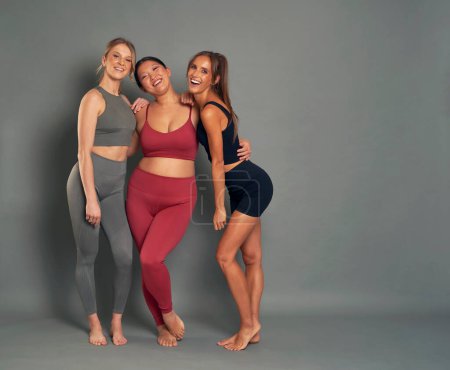 Photo for Full length portrait of three woman in sports clothes in studio shot - Royalty Free Image