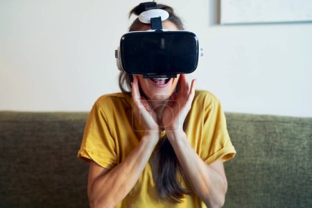 Photo for Amazed woman in Virtual Reality glasses having fun at home - Royalty Free Image