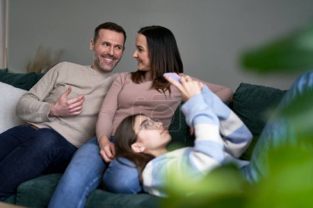 Photo for Caucasian family relaxing on the sofa together - Royalty Free Image