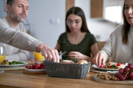 Photo for Caucasian family eating lunch together at home - Royalty Free Image
