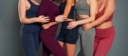 Photo for Group of five young unrecognizable women in sports clothes in studio shot - Royalty Free Image