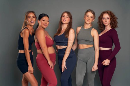 Photo for Portrait of five young women in sports clothes in studio shot - Royalty Free Image