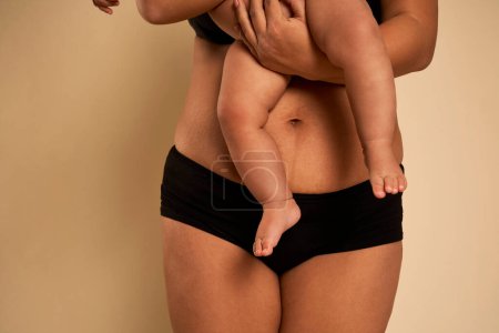 Photo for Lower section of woman carrying a toddler - Royalty Free Image