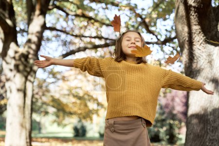 Photo for Little caucasian girl with arms outstretched in autumn season - Royalty Free Image