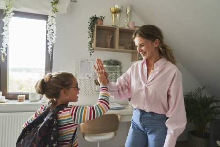 Photo for Caucasian mother and daughter doing high five before school - Royalty Free Image