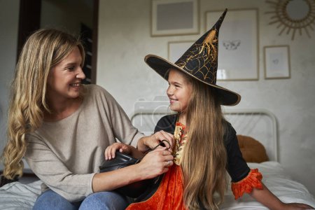 Photo for Caucasian mother and daughter preparing before Halloween party - Royalty Free Image