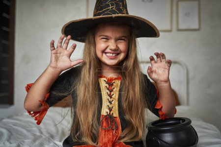 Photo for Portrait of  elementary age girl  wearing witch costume - Royalty Free Image