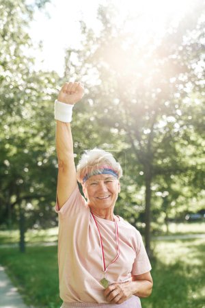 Photo for Portrait of senior woman celebrating victory with golden medal - Royalty Free Image