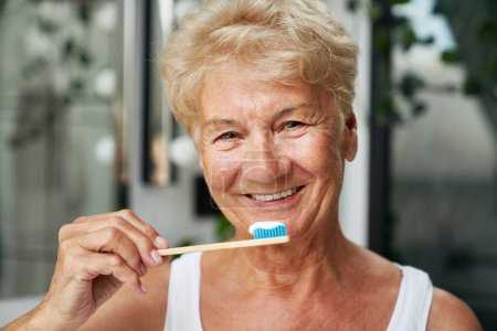 Foto de Mujer mayor a punto de cepillarse los dientes - Imagen libre de derechos