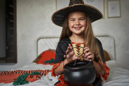 Photo for Portrait of elementary age girl wearing witch costume - Royalty Free Image