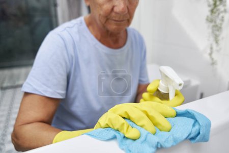 Photo for Unrecognizable senior woman cleaning the bath - Royalty Free Image