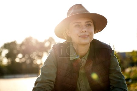 Photo for Female gardener looking away in sunny weather - Royalty Free Image