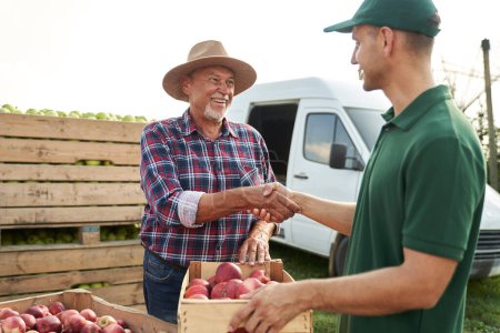 Photo for Handshake of orchard senior farmer and sales representative - Royalty Free Image