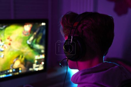 Photo for Close up of caucasian man playing game at night among neon lightning - Royalty Free Image