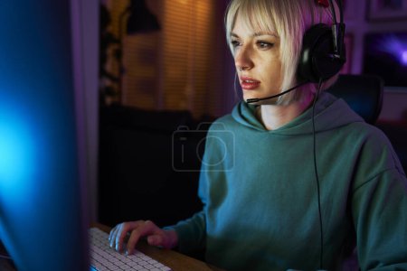 Téléchargez les photos : Jeune femme caucasienne jouer au jeu la nuit sur PC de bureau - en image libre de droit