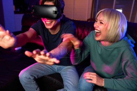 Photo for Young caucasian couple having fun while using VR glasses - Royalty Free Image
