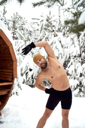 Photo for Caucasian man warming up before winter swim - Royalty Free Image
