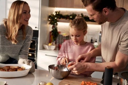 Photo for Caucasian family of three cooking before Christmas - Royalty Free Image