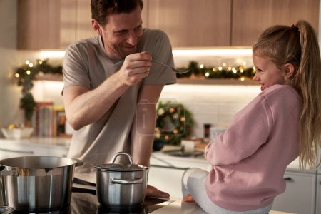 Photo for Caucasia father and daughter preparing food before Christmas - Royalty Free Image