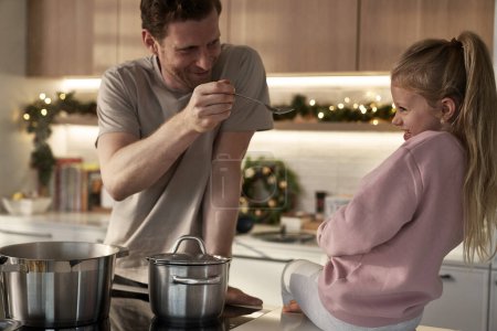Photo for Caucasia father and daughter preparing food before Christmas - Royalty Free Image