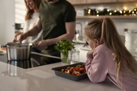 Photo for Caucasian family of four cooking before Christmas - Royalty Free Image