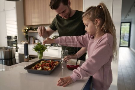 Photo for Caucasian father and daughter preparing food before Christmas - Royalty Free Image