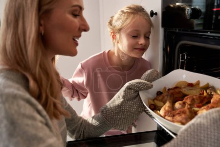 Photo for Caucasian mother and daughter preparing food before Christmas - Royalty Free Image
