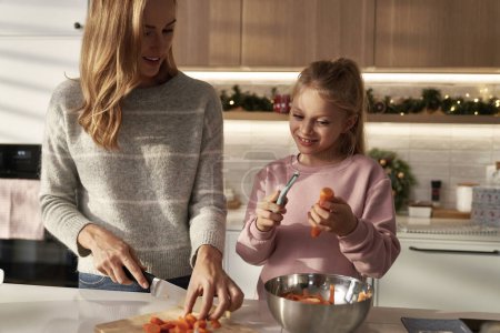Photo for Caucasian mother and daughter preparing food before Christmas - Royalty Free Image