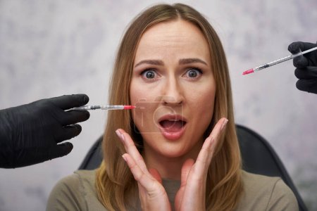Photo for Portrait of shocked woman among syringes - Royalty Free Image