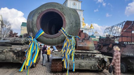 Photo for The barrel of a destroyed cannon in the ribbons of the Ukrainian flag - Royalty Free Image