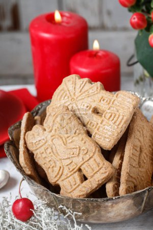 Bowl of speculaas biscuits on the christmas table. Festive decor
