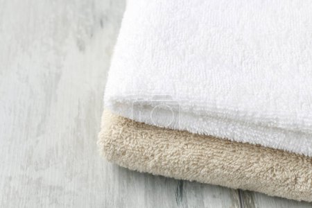 Photo for Two towels on wooden table. Relax time - Royalty Free Image