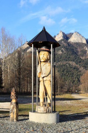 A sculpture depicting a raftsman at the harbor with mountains in the background.