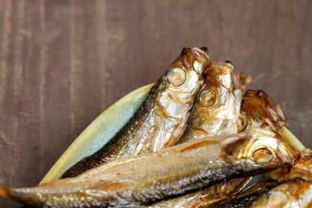 Photo for Smoked sprats on wooden table. Healthy food - Royalty Free Image