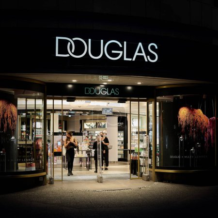 Photo for Berlin, Germany  September 09, 2022: Douglas perfumery store in the popular shopping street Kurfuerstendamm in Berlin in the evening - Royalty Free Image