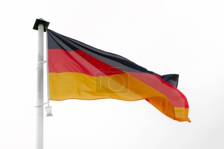 Photo for German flag waving in the wind on a flagpole with a white background - Royalty Free Image