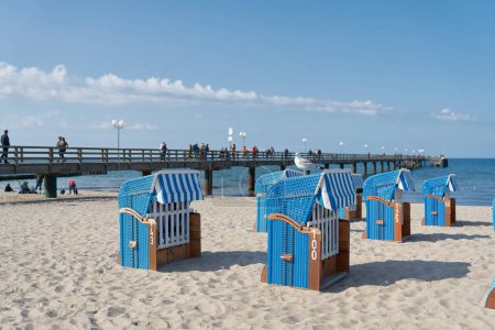 Photo for Beach chairs on the beach of Kuehlungsborn on the German Baltic Sea coast. In the background the pier. - Royalty Free Image