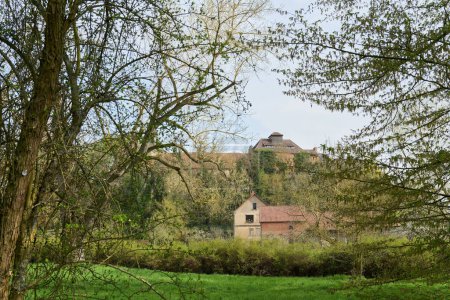 Photo for Farm buildings of Hundisburg Castle near Haldensleben on the hill seen from a forest path in a northerly direction - Royalty Free Image